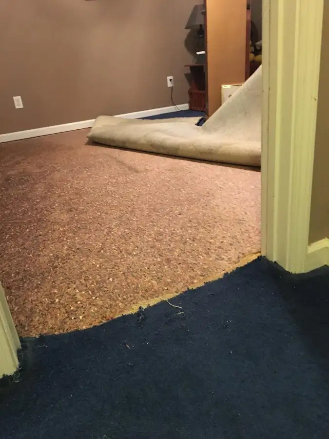 Carpet pad removal revealing water damage during Drying & Dehumidification in Bartlesville